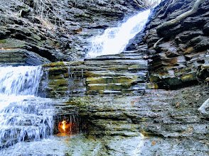 Eternal Flame burning behind waterfall and ice volcanoes on Lake Erie shoreline