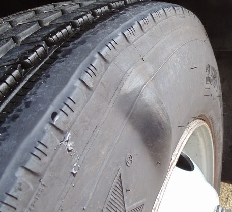 Inspecting tire sidewall for bulges or bubbles after hitting a pothole