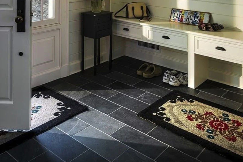 Waterproof porcelain tile flooring installed in a mudroom drop zone