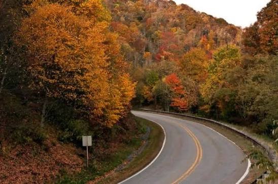 Scenic drive-up highway leading straight to a mountain ridge lookout peak